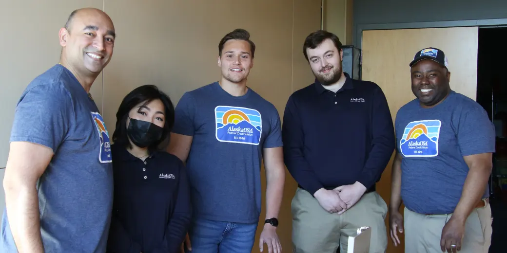 Four smiling Alaska USA employees